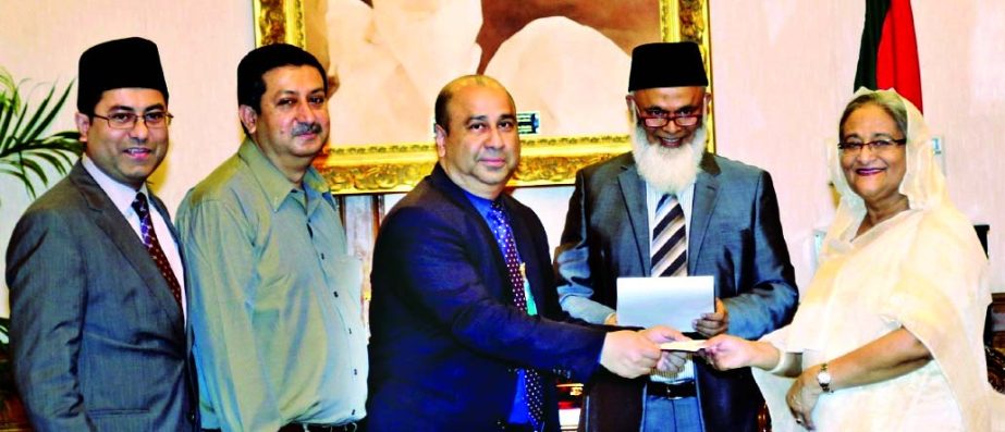 Humayun Kabir, Chairman of the Board of Directors of Modhumoti Bank Limited handing over the cheque for Tk 25 lakh to Prime Minister Sheikh Hasina for her relief fund recently. Shaikh Salahuddin, Vice-Chairman of the Board of Directors and Barrister Sheik