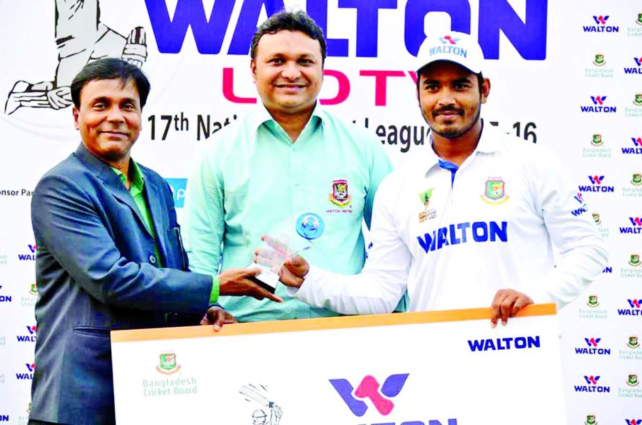 Shamsur Rahman (right) of Dhaka Metro receiving the Man of the Match award from Uday Hakim (left), Operative Director of Walton at the Khan Shaheb Osman Ali Stadium in Fatullah on Tuesday.
