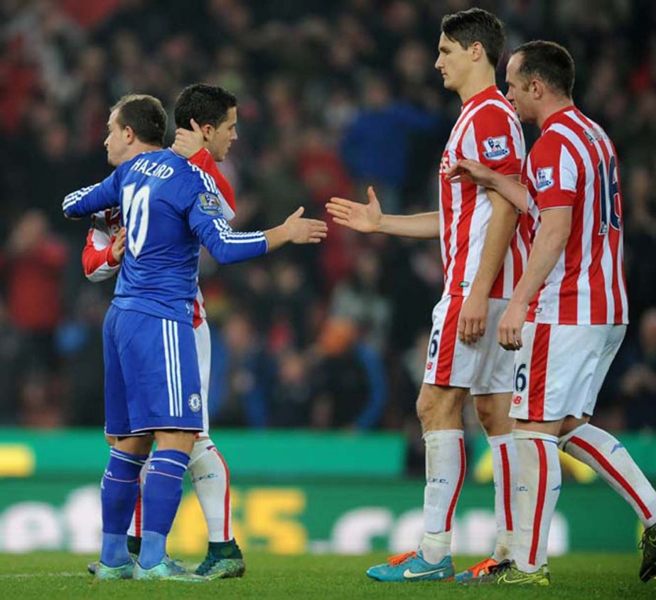Chelseaâ€™s Eden Hazard (left) is consoled by Stoke players after missing a penalty and Chelsea losing to Stoke on penalties during the English League Cup Fourth Round soccer match between Stoke City and Chelsea at the Britannia Stadium, Stoke on Tre