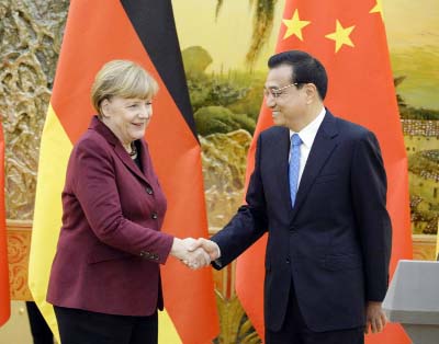 German Chancellor Angela Merkel, (left) shakes hands with Chinese Premier Li Keqiang after their press conference at the Great Hall of the People in Beijing on Thursday.