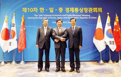South Korea's Trade, Industry and Energy Minister Yoon Sang-jick, centre, poses for the media with Japan's Economy, Trade and Industry Minister Motoo Hayashi, left, and China International Trade Representative Zhong Shan before the 10th trilateral econo