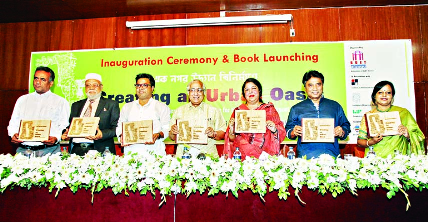 Speaker Dr Shirin Sharmin Chaudhury along with other distinguished guests holds the copies of a book titled 'Creating an Urban Oasis' organized by the Association of BUET Alumni at the National Museum in the city on Friday.