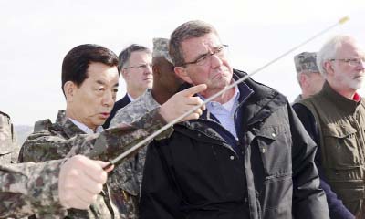 US Defence Secretary Ash Carter, (centre) looks towards North Korea as South Korean Defence Minister Han Min Koo, (left) briefs at an observation post near the border village of Panmunjom, which has separated the two Koreas since the Korean War, in Paju,