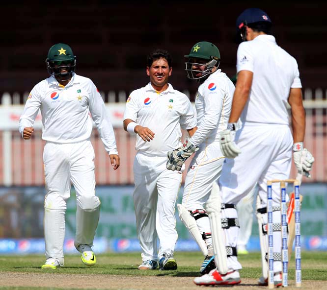 Pakistanâ€™s bowler Yasir Shah celebrates dismissal of England's Alastair Cook with his team mates during Pakistan and England Test match at the Sharjah Cricket Stadium in Sharjah, United Arab Emirates on Monday.