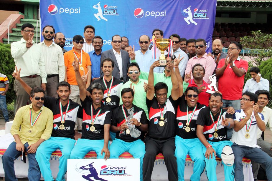 Members of Channel i cricket team, who became champion of Pepsi-DRU Media Cricket pose with the trophy along with guests at the Moulana Bhasani National Hockey Stadium on Monday.