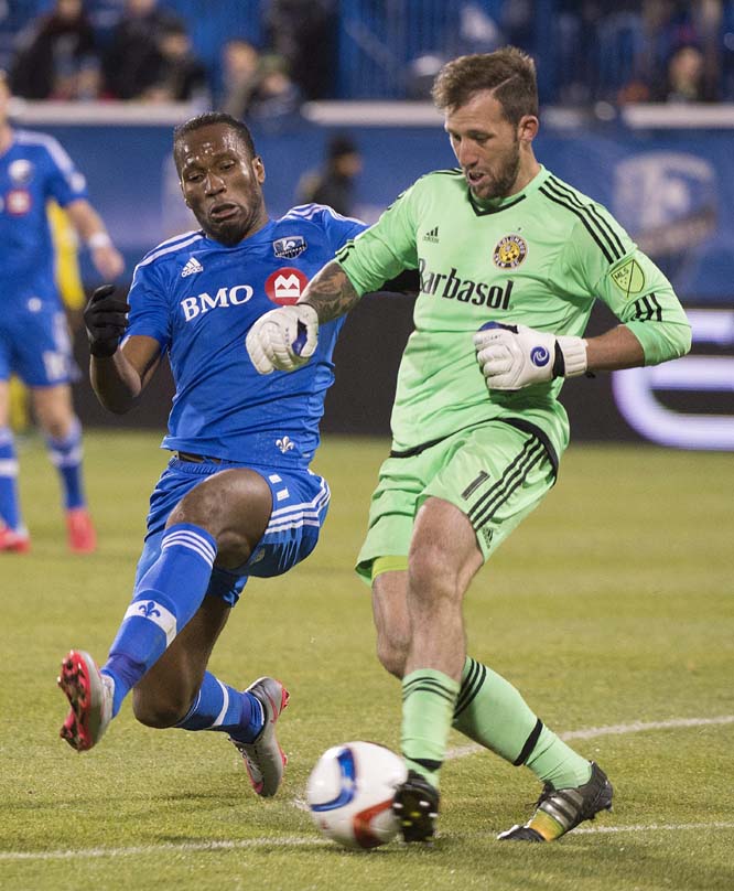 Montreal Impact's Didier Drogba, challenges Columbus Crew SC's goalkeeper Steve Clark during second half of an MLS Eastern Conference semi-final first-leg soccer match in Montreal on Sunday.