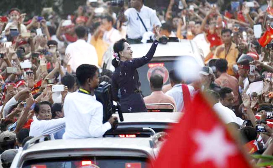 Myanmar pro-democracy leader Aung San Suu Kyi greets supporters while arriving at a campaign rally ahead of upcoming general elections in Yangon.