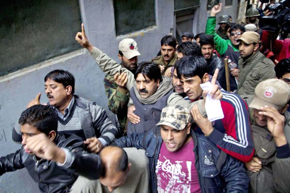 Kashmiris shout slogans after Indian police detained separatist People's Political Party (PPP) leader Hilal Ahmad War, centre wearing a shawl around his neck, in Srinagar, Indian controlled Kashmir, on Wednesday.