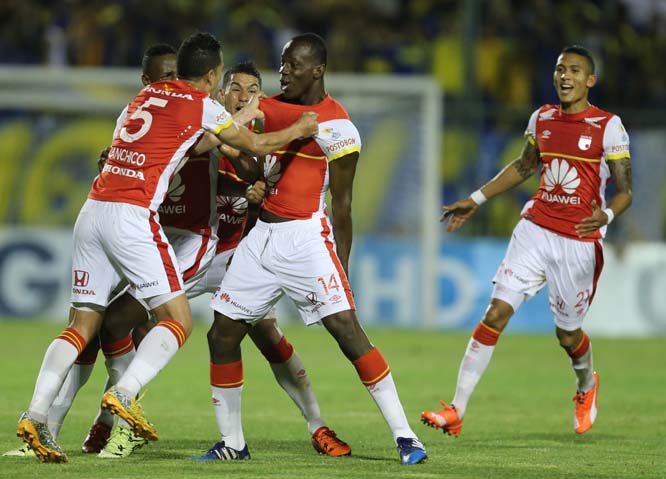 Baldomero Perlaza (center) of Colombia's Santa Fe celebrates with teammates after scoring against Paraguay's Sportivo Luqueno during the first leg of the Copa Sudamericana semi-finals soccer match in Luque