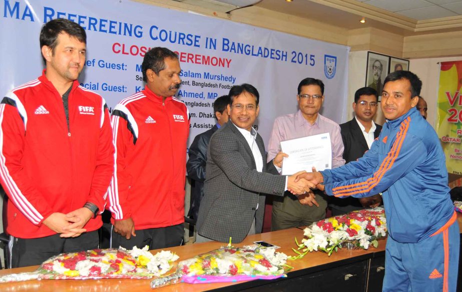 A participant of FIFA MA Referring Course receiving the certificate from Abdus Salam Murshedy