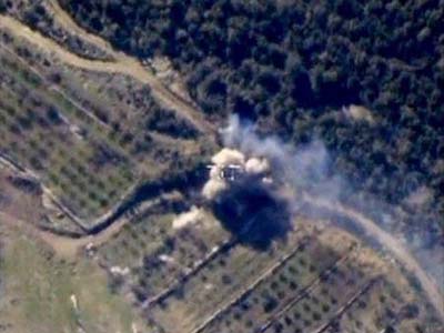 Smoke rising after Russian air strikes on a militants' fortified point in Latakia province