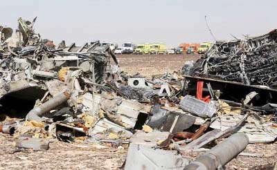 The remains of a Russian airliner are seen as rescue crews wait at the crash site in al-Hasanah area in El Arish city