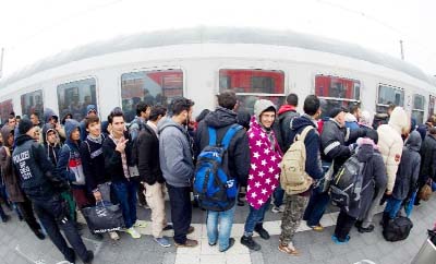 Migrants enter a special train to bring them to Duesseldof, western Germany, on a platform of the railway station in Passau, southern Germany.