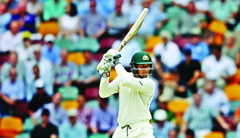 Usman Khawaja sends one racing through the off side on the second day of the 1st Test between Australia and New Zealand at Brisbane on Friday.