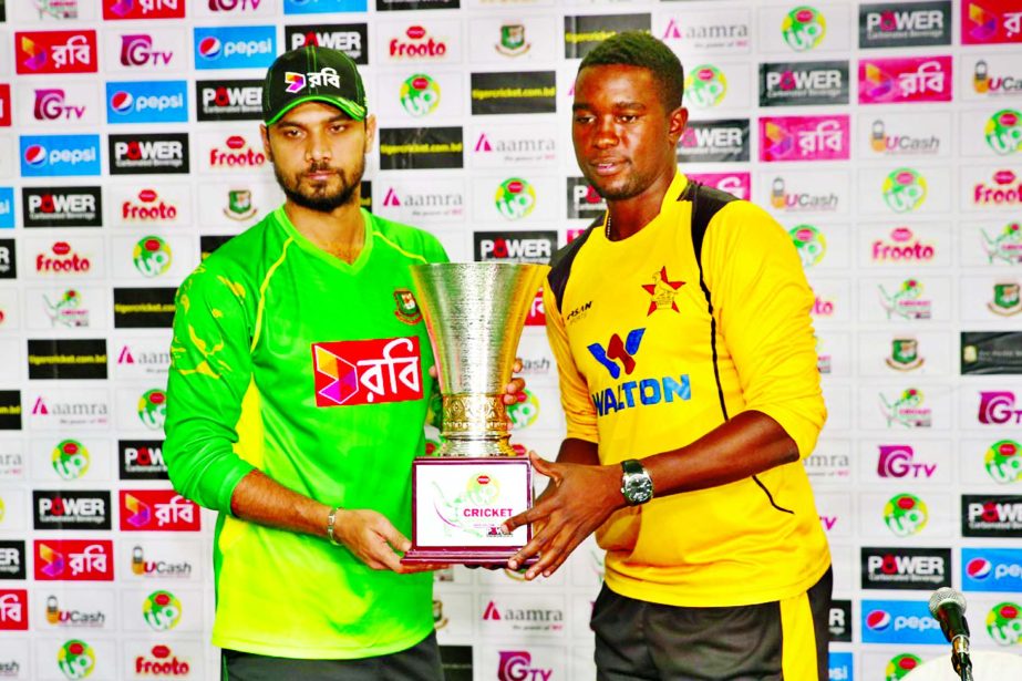 Captain of Bangladesh National Cricket team Mashrafe Bin Mortaza (left) and Captain of Zimbabwe National Cricket team Elton Chigumbura pose with the three-match ODI series trophy at the Pan Pacific Sonargaon Hotel on Friday.