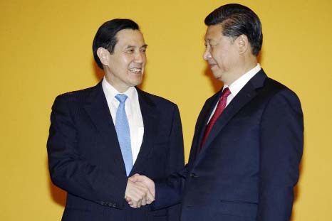 Chinese President Xi Jinping, right, and Taiwanese President Ma Ying-jeou, left, shake hands at the Shangri-la Hotel on Saturday in Singapore.