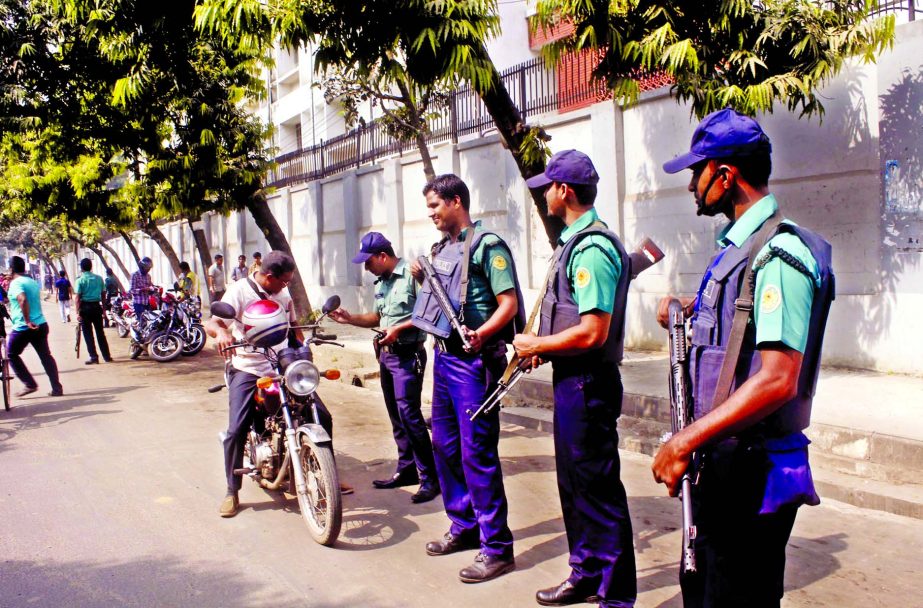 Law enforcers equipped with loaded arms remain high alert at check posts across the capital in a bid to tackle the terror acts and the emergency situation. This photo was taken from in front of RAJUK check post on Saturday.