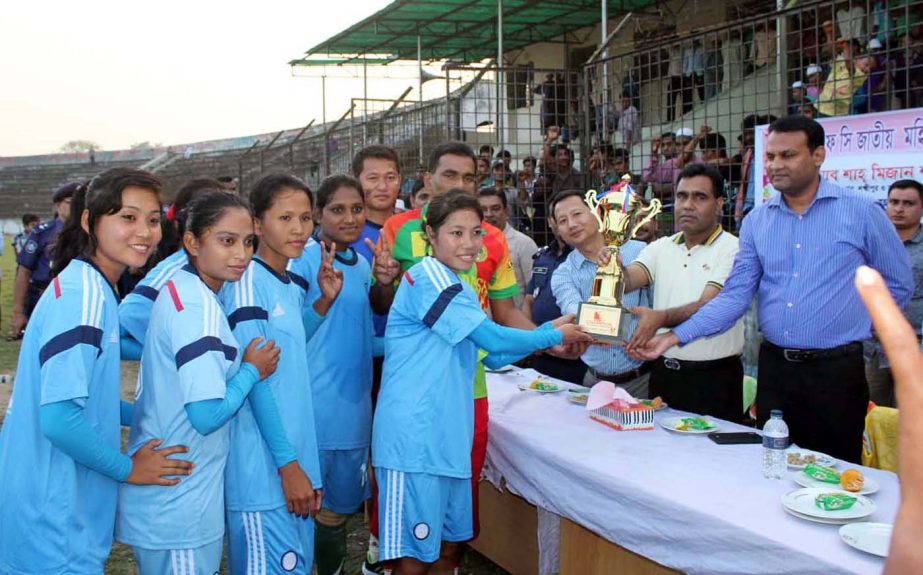 Ansar & VDP, the champions of the Chittagong Division of KFC National Women's Football Championship receiving the champions trophy from the chief guest at the Laxmipur Stadium on Sunday.
