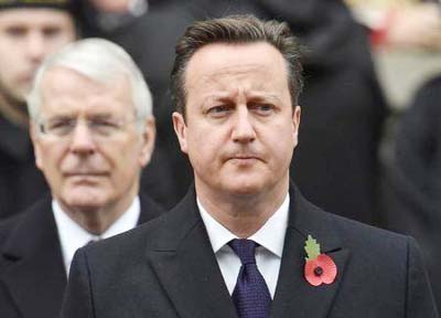 Britain's Prime Minister David Cameron stands in front of former Prime Minister John Major at the Remembrance Sunday ceremony at the Cenotaph in central London on Sunday.