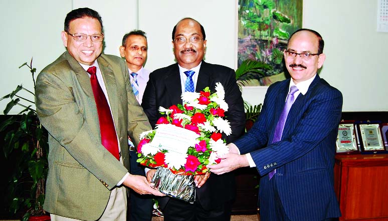 Md. Badiul Alam, Managing Director (CC) of National Bank Limited presented a flower bouquet to Deputy Governor of Bangladeh Bank S K Sur Chowdhury on his winning 'Mother Teresa Memorial Award' recently. Abdul Hamid Mia, Additional Managing Director of N