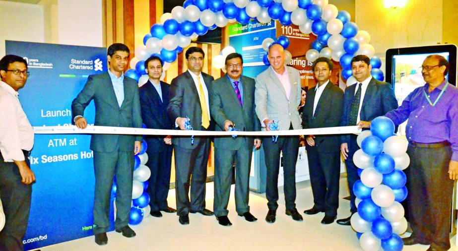 Aditya Mandloi, Head of Retail Banking, Standard Chartered Bank; Kazi Ashfaq Shams, Managing Director, Six Seasons Hotel along with other senior officials of both organizations inaugurating the new ATM booth of the bank at Six Seasons Hotel recently.