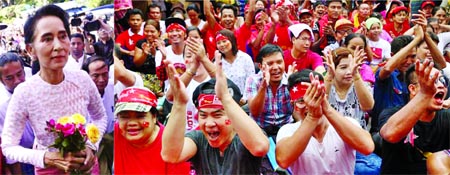 Supporters of the Opposition NLD celebrate election victory when Suu Kyi arrives at her Party Headquarters in Yangon on Monday.