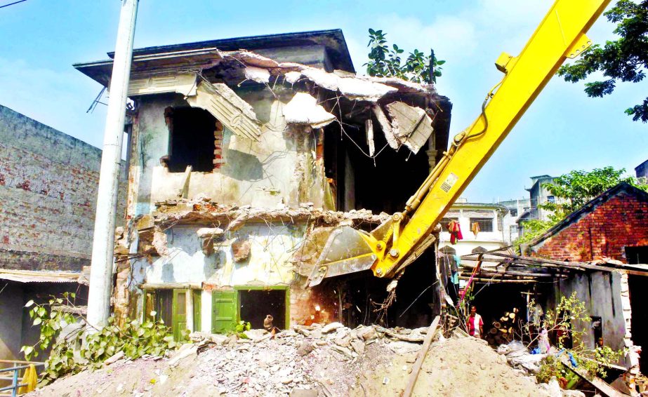 Illegal establishment on the bank of the River Buriganga being bulldozzed by BIWTA authorities on Tuesday.