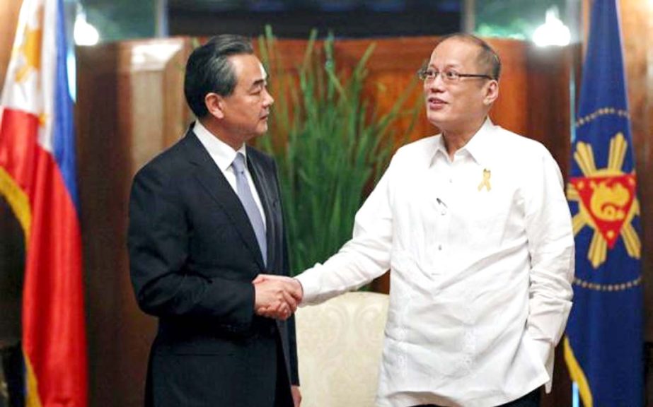 Philippine President Benigno Aquino greets Chinese Foreign Minister Wang Yi (L) after his courtesy call at the presidential palace in Manila.
