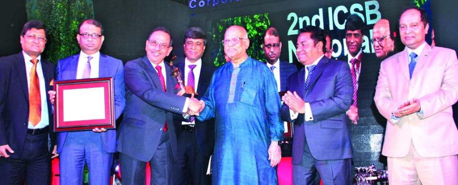 Finance Minister A M A Muhith handing over 'ICSB National Award for Corporate Governance Excellence 2014' in the Banking Companies category to Meah Mohammed Abdur Rahim, Director of Eastern Bank Ltd. (EBL) at a ceremony organised by Institute of Charter