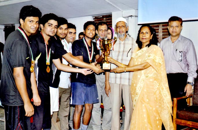 Vice-Chancellor of BUET Professor Khaleda Ekram handing over the championship trophy of the Inter-Hall Badminton Competition to the team leader of Sher-e-Bangla Hall at the BUET Play Ground on Tuesday. Professor Dr M Delwar Hossain, Director, Directorate