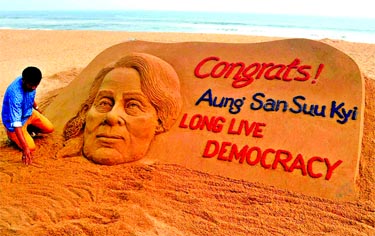 Sand artist Sudarshan Pattnaik creates a sand sculpture with a message Congrats! Aung San Suu Kyi, Long Live Democracy. Internet photo