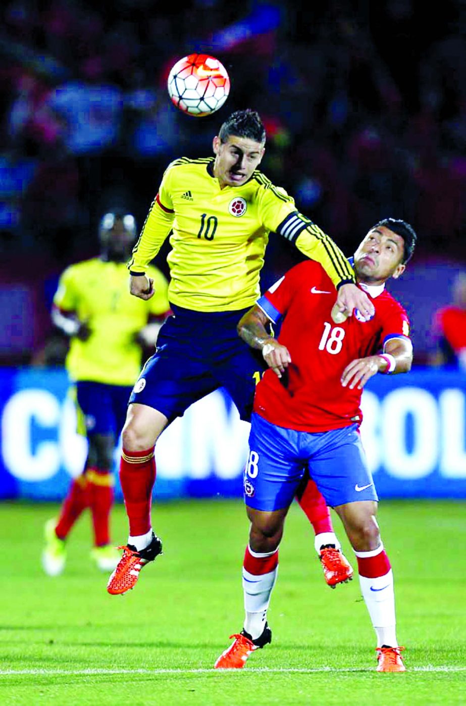 Colombia's James Rodriguez (left) heads the ball with Chile's Gonzalo Jara during a 2018 World Cup qualifying soccer match in Santiago, Chile on Thursday.