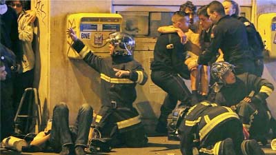 Rescuers helping injured people at rock concert centre in the French capital Paris on Friday.