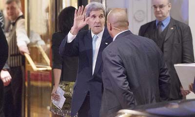 US secretary of State John Kerry waves as he arrives at the Bristal hotel on Friday in Vienna, Austria on the eve of Syrian peace talks.