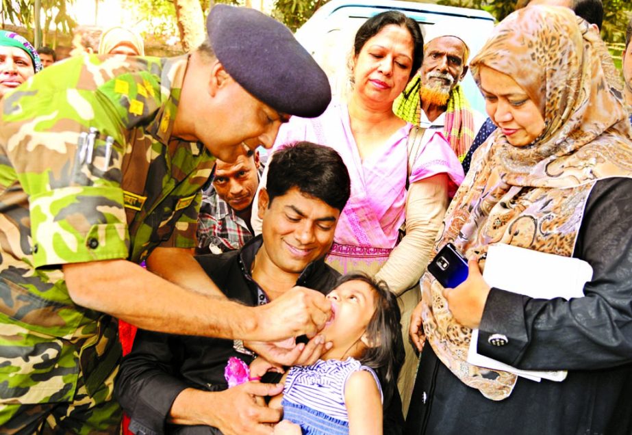 Chief Health Officer of Dhaka South City Corporation Brig Gen Mahbubur Rahman administering Vitamin A capsule to a child at the corporation's Zone-3 office in the city's Azimpur on Saturday marking Vitamin A Plus campaign.