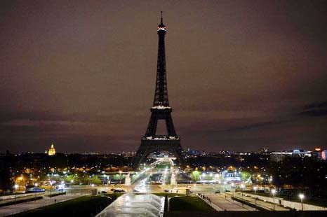 The Eiffel Tower turns its lights off as France mourns on Saturday, following deadly attacks in Paris.