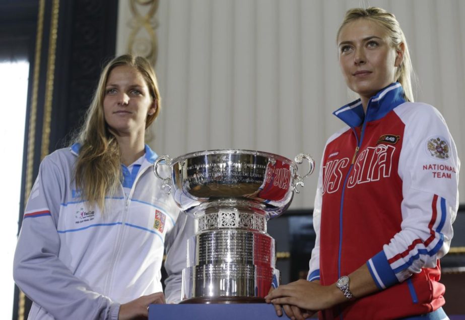 Karolina Plskova (left) of Czech Republic and Maria Sharapova (right) of Russia pose for a photo after the draw for the tennis Fed Cup Final between Czech Republic and Russia in Prague, Czech Republic on Friday.