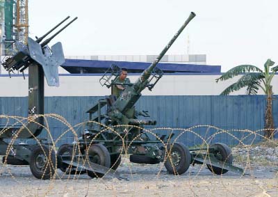 A Philippine marine checks an anti-aircraft gun placed around the venue for this week's APEC (Asia Pacific Economic Cooperation) Summit of Leaders on Monday in Manila, Philippines.