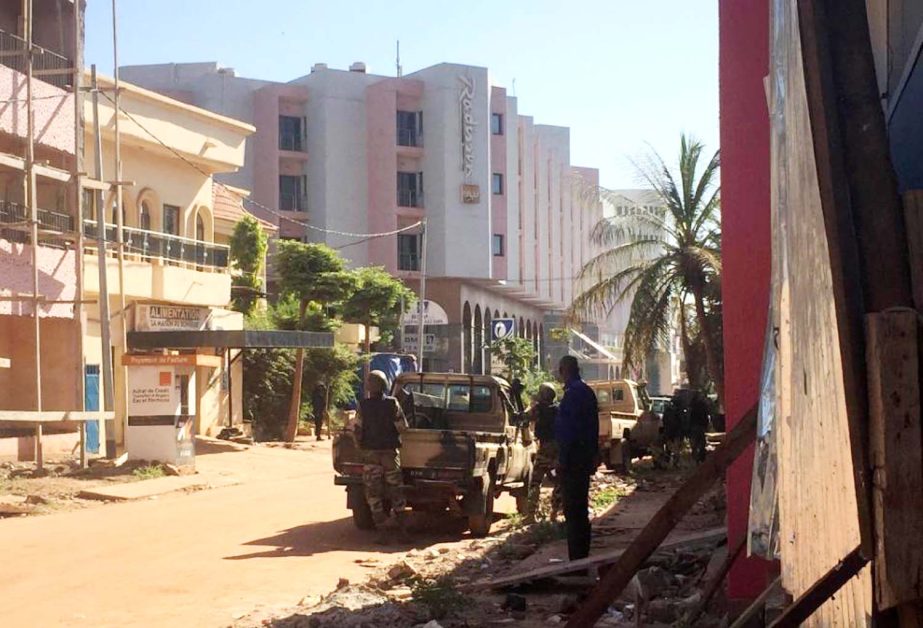 Malian troops take position outside the besieged Radisson Blu hotel in Bamako on Friday .
