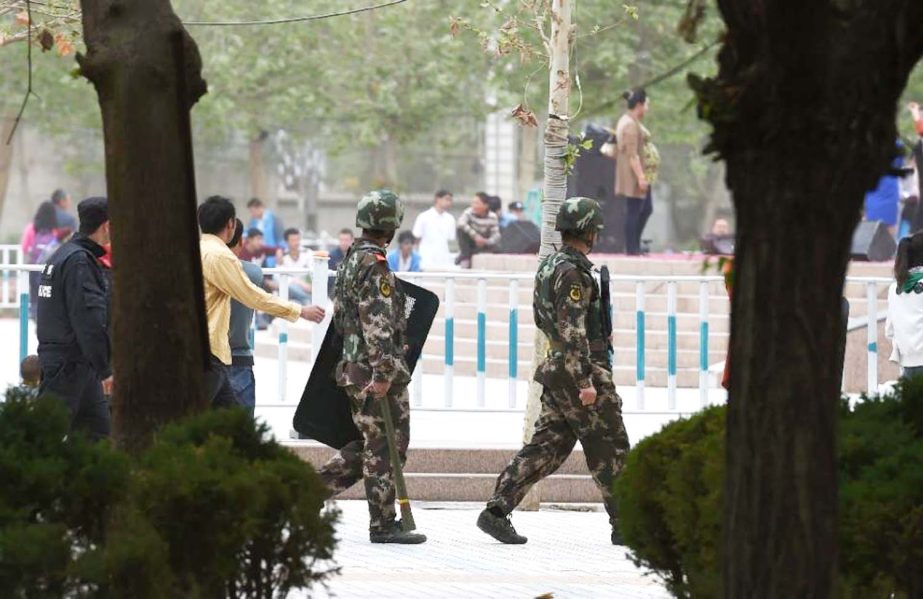 Paramilitary police patrol beside the central square in Hotan, in China's western Xinjiang region.