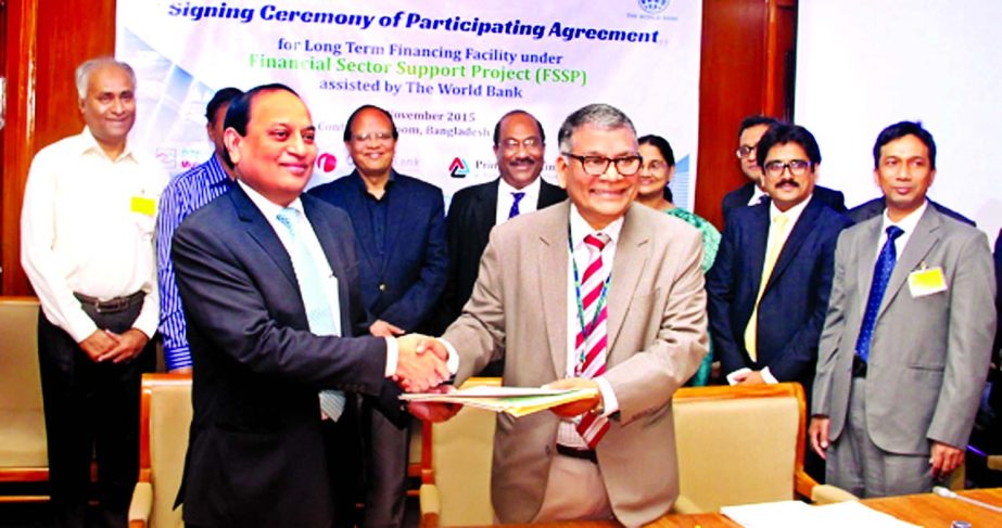 The Managing Director of ONE Bank Ltd. M. Fakhrul Alam exchanging participating agreement with Md. Ahsan Ullah, Executive Director of Bangladesh Bank and Project Director of FSSP in the presence of the Governor Dr. Atiur Rahman at the conference room of t