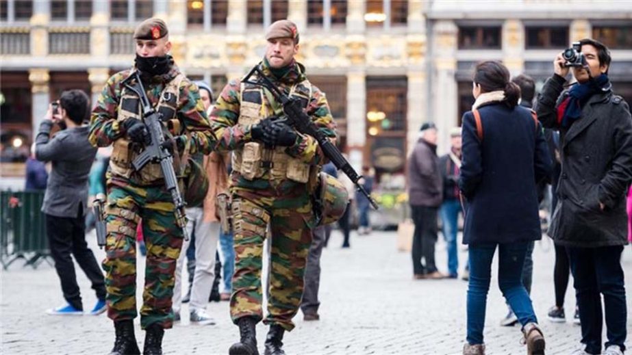 Belgian soldiers patrol in a shopping area after security was tightened following the fatal attacks in Paris, in Brussels, Belgium on Saturday.