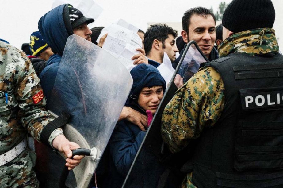 Migrants and refugees are pushed back by police as they try to cross the Greek-Macedonian border near Gevgelija on Friday.