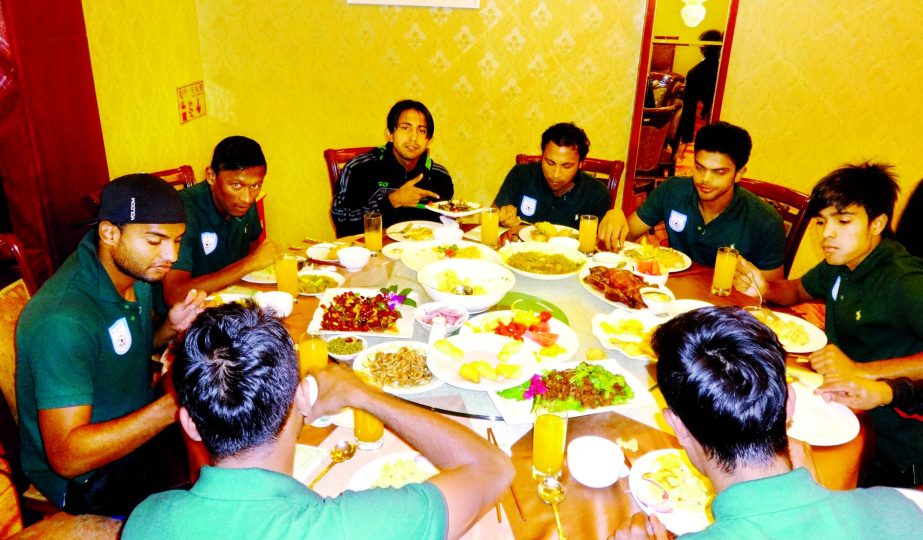 Members of Bangladesh National Football team taking food at the Mangshi Hotel in China on Saturday.