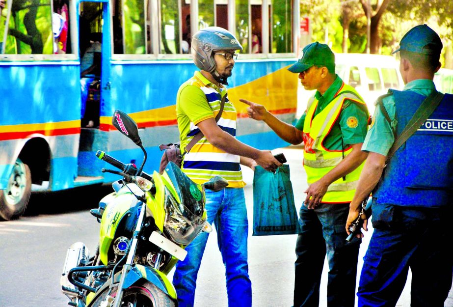 Stringent security measures were taken across the capital following the executions of Mozaheed and SQ Chy's verdicts. Photo shows law enforcers searching and checking a motor rider at a checkpost near Sangsad Bhaban on Saturday.