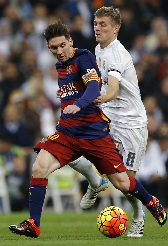 Barcelona's Lionel Messi fights for the ball with Real Madrid's Toni Kroos during the first clasico of the season between Real Madrid and Barcelona at the Santiago Bernabeu Stadium in Madrid, Spain on Saturday.