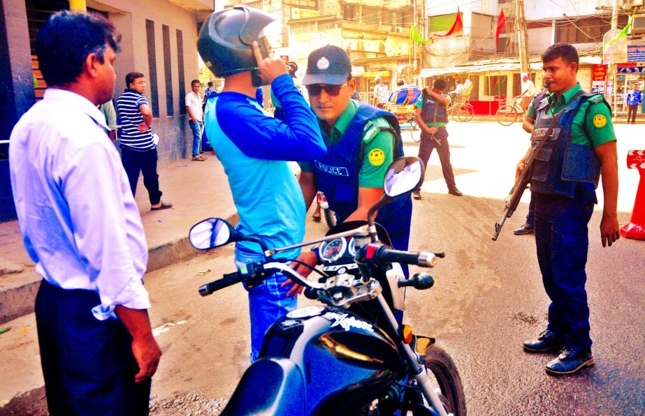 Strict security steps being taken in the capital following the executions of Ali Ahsan Mohammad Mojaheed and SQ Chowdhury. Photo shows law enforcers continue searching motor cycle rider at a temporary chiekpost near Bangabhaban on Sunday.