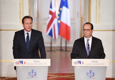 French President Francois Hollande (right) and British Prime Minister David Cameron give a joint statement following talks at the Elysee Palace in Paris, on Monday.