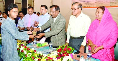 BOGRA: Abdul Mannan MP distributing crests among the meritorious students of PSC and JSC for their good results at Muktijoddha Aminul Huq Dulal Auditorium organised by Bogra Zilla School on Friday.