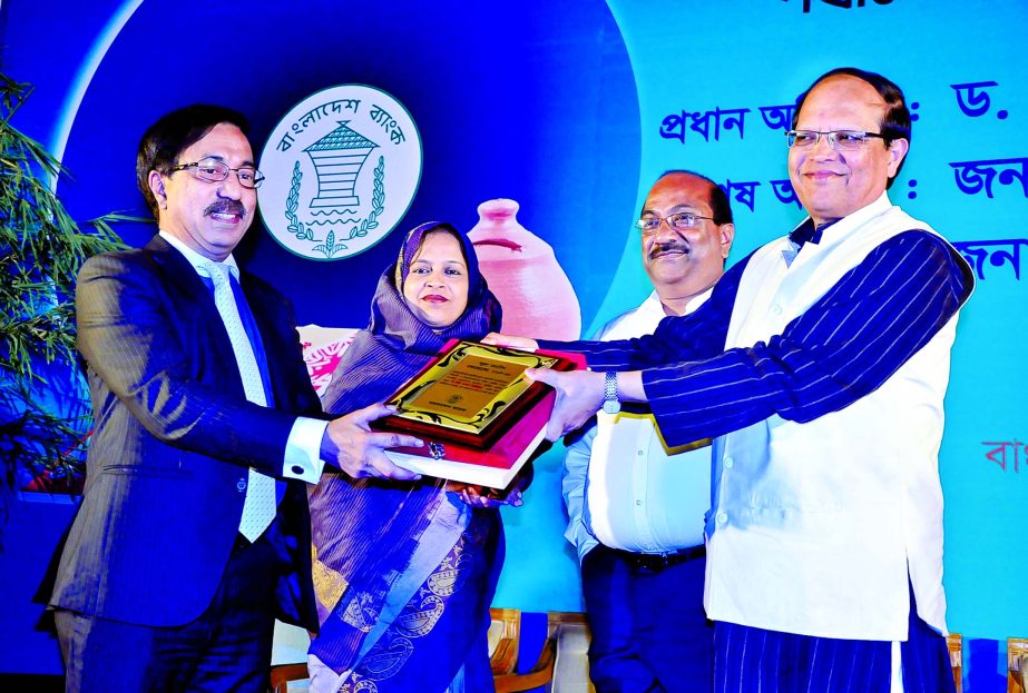 Dr Atiur Rahman, Governor of Bangladesh Bank handing over a crest and certificate to Faruq M Ahmed, Additional Managing Director of City Bank as a memento of outstanding contribution in popularizing 'School Banking' among students at a School Banking Co